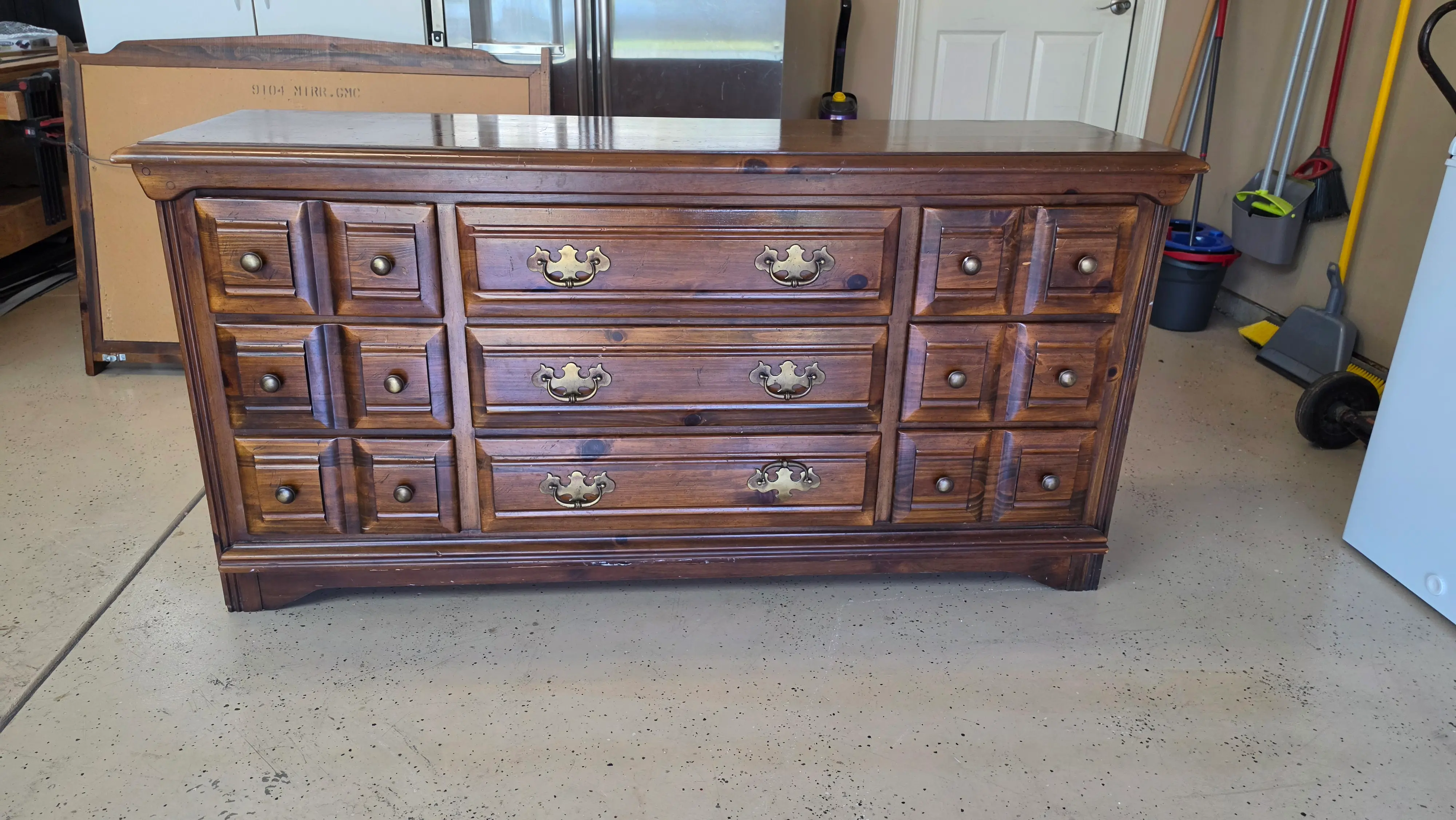 Pine dresser before refinishing, with a worn orange-brown finish and dated colonial brass hardware